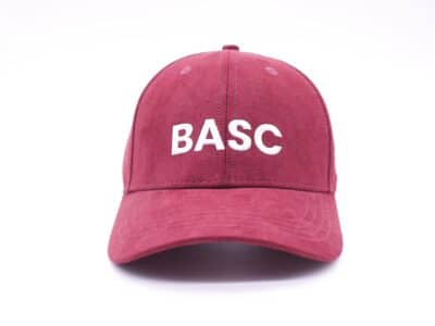 Women in shooting maroon-branded cap