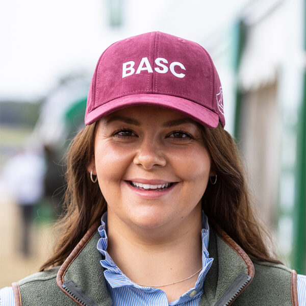 Women in shooting maroon cap