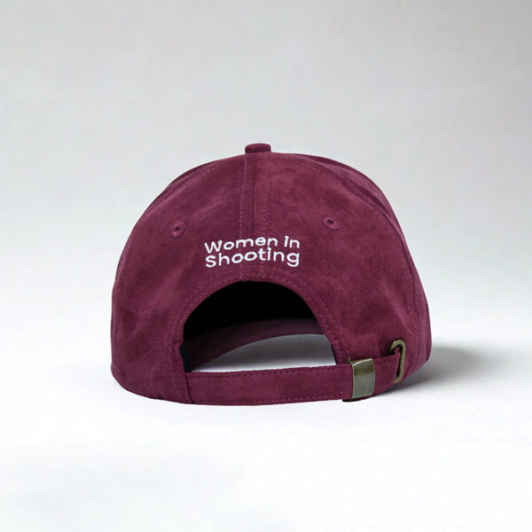 Women in shooting maroon cap