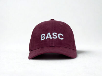 Women in shooting maroon cap