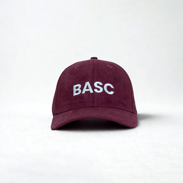 Women in shooting maroon cap