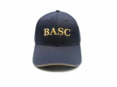 Navy BASC cap with gold embroidered logo and curved peak