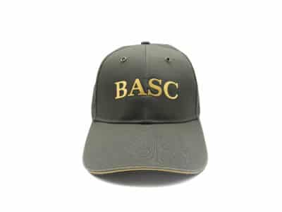 Sage green BASC baseball cap with raised gold BASC lettering on the front, shown from the front on a white background.